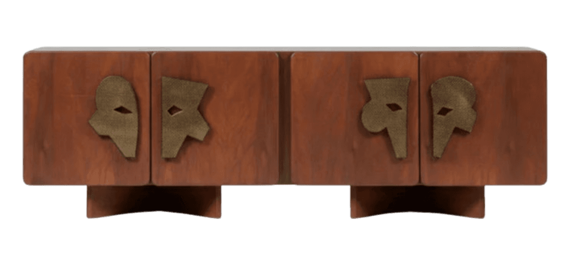 A low, rectangular cabinet with four doors. The cabinet is constructed from wood with a warm, reddish-brown finish. Each door features a unique, abstract metallic appliqué in a brass-like finish, with geometric cutouts. The cabinet is supported by two block-like legs that are set back from the front. — 3D model