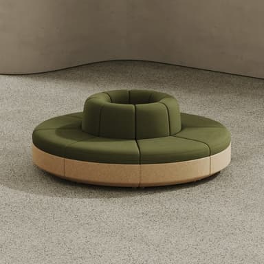 A circular modular seating unit featuring olive green textile upholstery for the cushions and a light-toned, possibly wood or composite, base. The unit has a central cylindrical opening, suggesting it is designed to accommodate a planter or other decorative element. The seating surface is divided into wedge-shaped upholstered segments, indicating a modular construction. — 3D model