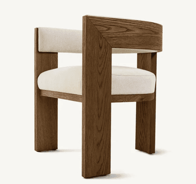 A modern armchair featuring a robust wooden frame with angular lines for the legs and integrated arms, complemented by a distinctive curved backrest. The seat and an interior section of the back are upholstered in a light, neutral fabric. — 3D model