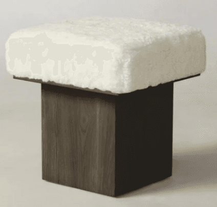 A contemporary square ottoman featuring a thick, plush, white boucle upholstered top, supported by a minimalist dark wood cube base with a visible grain texture. — 3D model