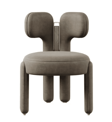 A contemporary sculptural accent chair featuring plump, rounded forms. It has a distinctive bi-lobed or 'eared' backrest, a circular upholstered seat, and four thick, rounded upholstered legs. A vertical decorative element consisting of a brass frame with a marble or stone inlay is positioned centrally on the backrest. The chair is upholstered in a smooth, soft fabric, likely velvet, in a taupe or muted brown color, with brass-finished details on the leg caps and back inlay. — 3D model