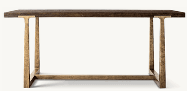 A console table featuring a dark stained wooden top with a pronounced grain texture and a rough-hewn appearance. The base is constructed from metal with a distressed, antique brass-like finish, exhibiting a textured, hammered surface. The legs are elongated and rectangular, connected by a lower horizontal stretcher, creating a minimalist yet robust structure. — 3D model