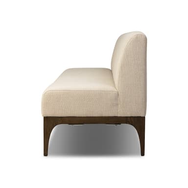 A rectangular bench with a high backrest, upholstered in a textured light beige fabric. The bench is supported by a dark wood frame and four angled legs, two visible at the front and two implied at the back. The design appears modern and minimalist. — 3D model