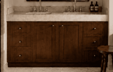 A contemporary double sink bathroom vanity featuring a dark brown wooden cabinet, a light beige stone countertop, two integrated undermount sinks, and brushed nickel faucets and hardware. The vanity offers ample storage with multiple drawers on both sides and central cabinet doors. — 3D model
