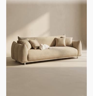A contemporary sofa featuring a distinctive sculptural form, upholstered in a textured boucle fabric in a neutral beige color. It has soft, rounded edges, subtly fluted armrests, and rests on slender cylindrical metal legs. — 3D model