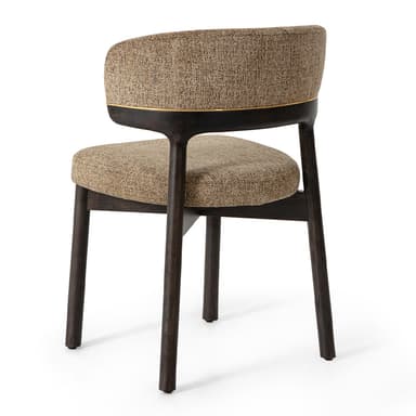 A modern upholstered chair with a dark wood frame and a curved backrest. The seat and backrest are upholstered in a textured, speckled fabric. A thin gold trim detail accents the top edge of the backrest. The chair has four tapered legs. — 3D model