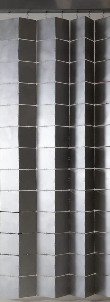 A room divider composed of multiple square, metallic panels arranged in a flexible, accordion-like structure. The panels are connected by visible fasteners, allowing them to fold and pivot. The surface reflects light, creating a shimmering, alternating pattern of light and dark squares. — 3D model