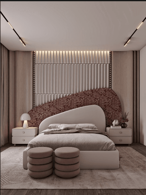 A modern platform bed featuring a rounded upholstered headboard, integrated into a large wall-mounted panel system. The wall panel comprises a light wood-toned section with vertical ribbed detailing and a studded perimeter, alongside an asymmetrical, richly patterned upholstered section. The bed frame is upholstered in a light, neutral fabric, and it is accompanied by two stacked circular footstools matching the patterned upholstery. — 3D model