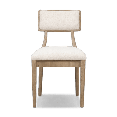 A dining chair with a wooden frame and upholstered seat and backrest. The seat and backrest are covered in a textured, light-colored fabric. The wooden frame has a light, natural finish and features a fluted design along the apron below the seat. The backrest is rectangular with gently rounded corners and is supported by two curved wooden uprights. — 3D model