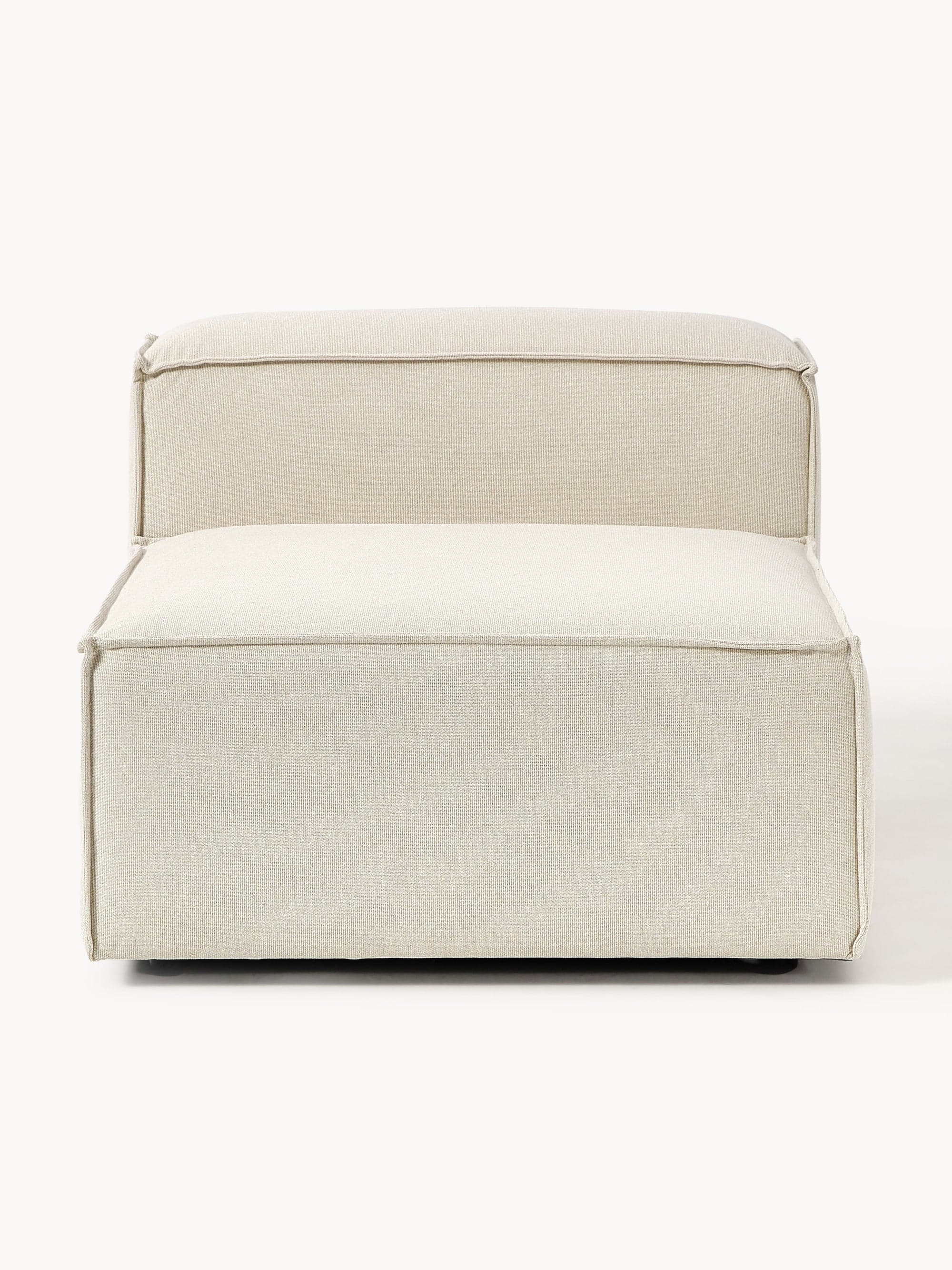 A contemporary, armless upholstered chair with a low profile. It features a deep seat and a slightly reclined backrest, both with pronounced piping along the edges. The fabric appears to be a textured linen or similar woven material. The chair has a minimalist design and is presented against a white background. — 3D model