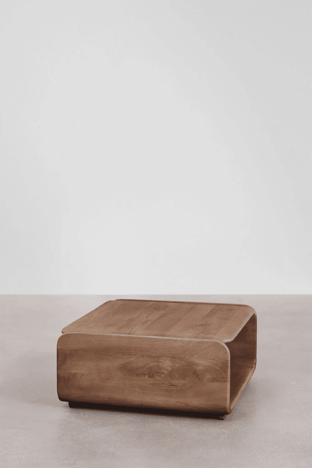 A contemporary wooden coffee table with a distinctive U-shaped or curved form. The structure appears to be constructed from bent wood or segmented wood panels that create a seamless, flowing design. The top surface is flat and rectangular, with rounded edges. The base is integrated into the curved structure, giving it a modern and sculptural appearance. — 3D model
