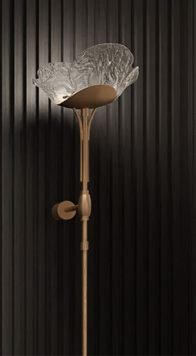 A tall, slender floor lamp featuring a metallic bronze or gold-finished base and stem, topped with a distinct, upward-facing, textured glass shade shaped like an opening flower. The stem appears to have an adjustable section. — 3D model