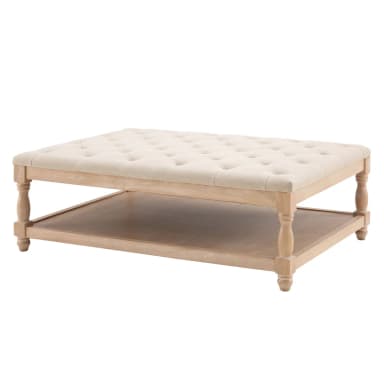 A rectangular coffee table with a tufted upholstered top and a lower wooden shelf. The table features turned legs and a light wood finish. — 3D model