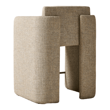 A contemporary armchair with a cubist-inspired design. It features a fully upholstered body with a textured, woven fabric in a neutral beige-brown hue. The armchair has high, straight armrests that extend down to form the sides of the base, creating a unified, solid form. A thin, cylindrical metal bar in a brass finish spans the width between the two side panels of the base, serving as a subtle structural element and footrest. The seat and back are well-padded, suggesting comfort. — 3D model