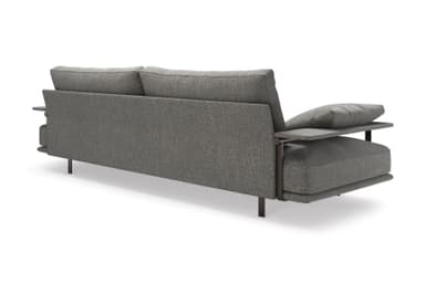 A contemporary two-seater sofa upholstered in a grey, textured fabric. It features a visible dark metal frame that extends to form the armrests and slender rectangular legs. The backrest is composed of loose cushions. One armrest is topped with an additional small cushion. The overall design is minimalist and modern. — 3D model