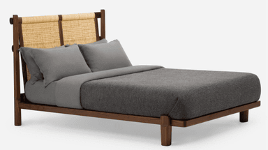 A loveseat seen from the back, featuring a dark walnut wood frame and a light-colored woven natural fiber backrest. The frame is composed of horizontal and vertical wooden members, within which two distinct woven panels are secured. A dark gray cushion is partially visible through the woven material. — 3D model