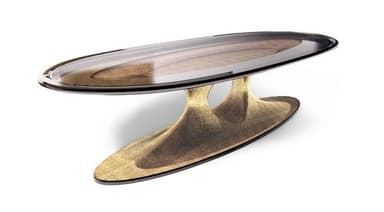 An oval coffee table featuring a smoked glass top with a patterned insert, supported by a sculptural, hourglass-shaped base with a textured, metallic finish. The design exhibits a contemporary and organic aesthetic. — 3D model