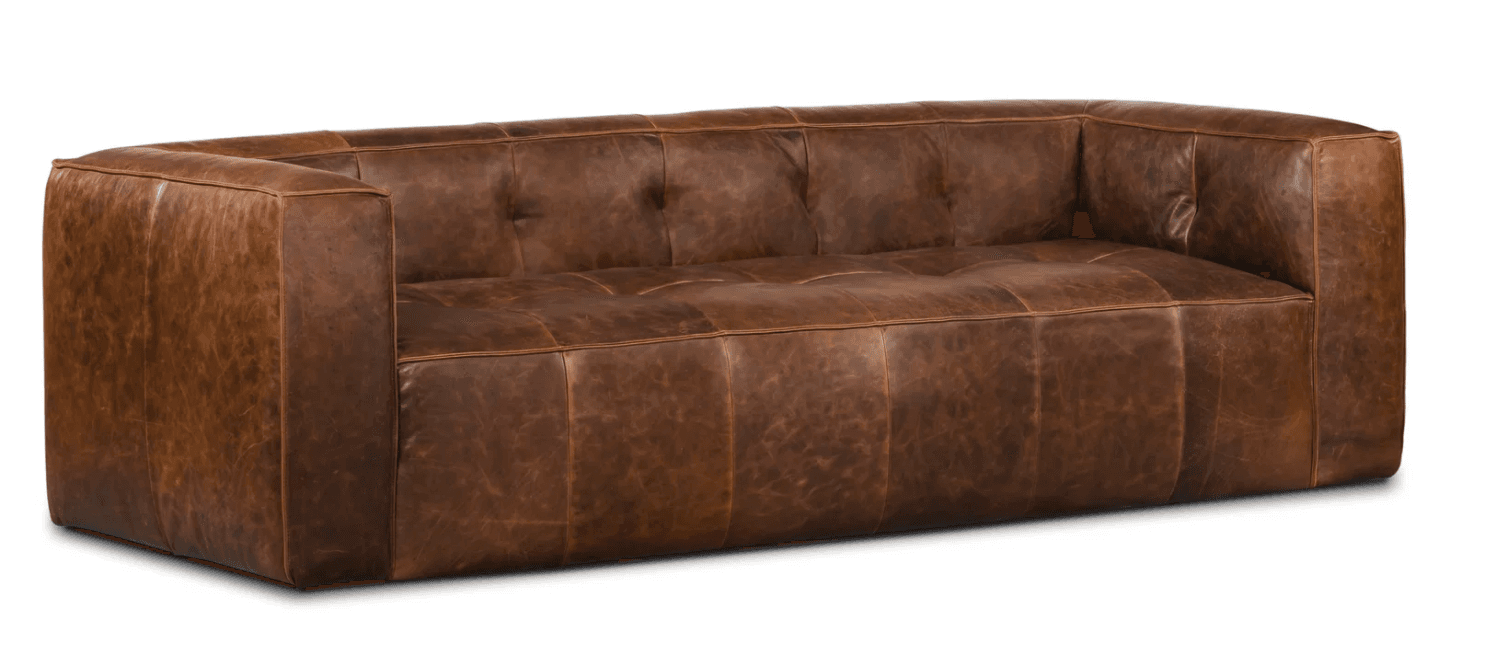 A mid-century modern inspired leather sofa with a low profile and square arms. The sofa features tufted seat and back cushions, with stitching details creating a panel effect on the front and sides. The upholstery appears to be distressed or aged leather. — 3D model