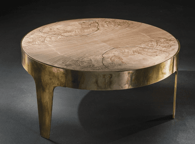 A round coffee table featuring a light-toned natural wood top with prominent grain patterns, supported by a distressed brass-finished metal base with integrated, flared legs. — 3D model