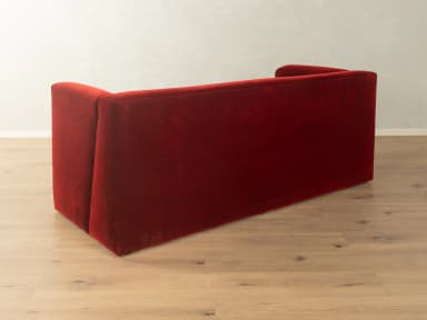 A two-seater sofa with a distinct geometric design. It features deep red velvet upholstery, high, angular armrests that extend downwards to form the base, and a single seat cushion. — 3D model
