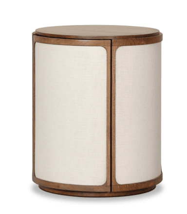 A cylindrical side table featuring a flat wooden top and a matching wooden base. The body is constructed from multiple vertical panels, each framed with wood and upholstered with a light-colored, textured fabric. — 3D model