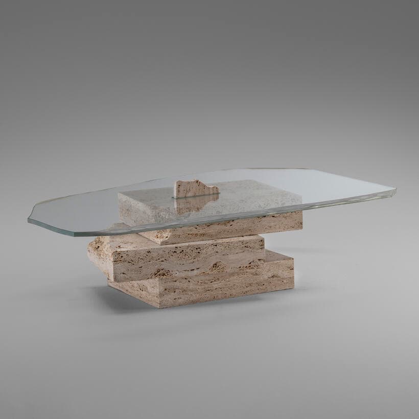 A postmodern coffee table featuring an irregular-shaped glass top supported by a stacked, multi-level base constructed from natural, rough-hewn travertine blocks. The base comprises several geometric and organic stone elements, creating a sculptural and robust foundation for the transparent tabletop. — 3D model