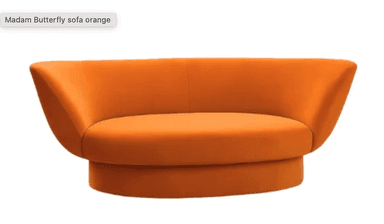 A modern, low-profile sofa with a rounded, sculptural form. The sofa features a single bench-style seat cushion and a curved, enveloping backrest. It is upholstered in a soft, textured fabric and sits on a solid, circular base. The design emphasizes smooth lines and a cohesive silhouette. — 3D model