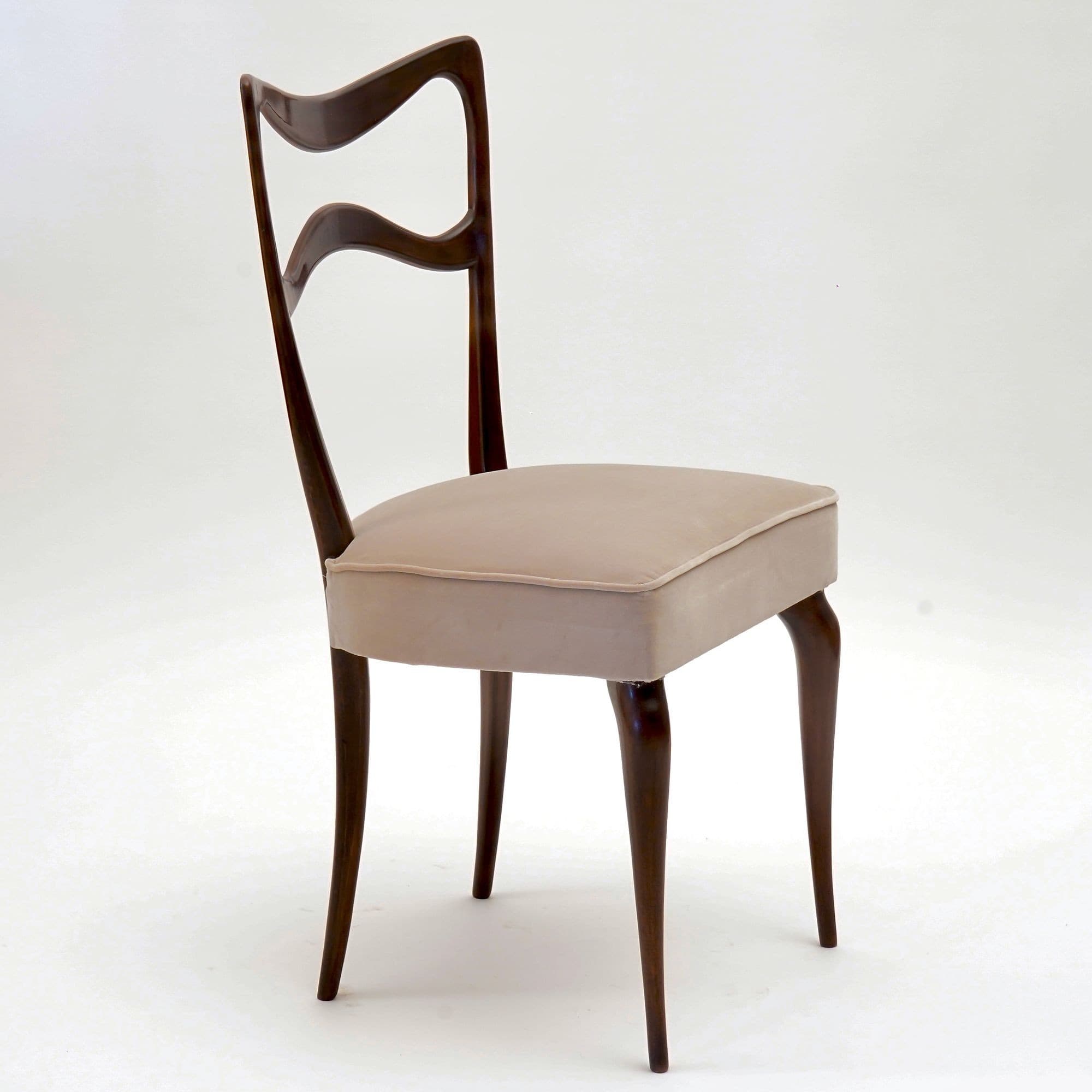 A side chair with a curved, open backrest and a padded seat. The frame and legs are made of dark wood, with a sculpted, organic form. The seat is upholstered in a light-colored fabric. — 3D model