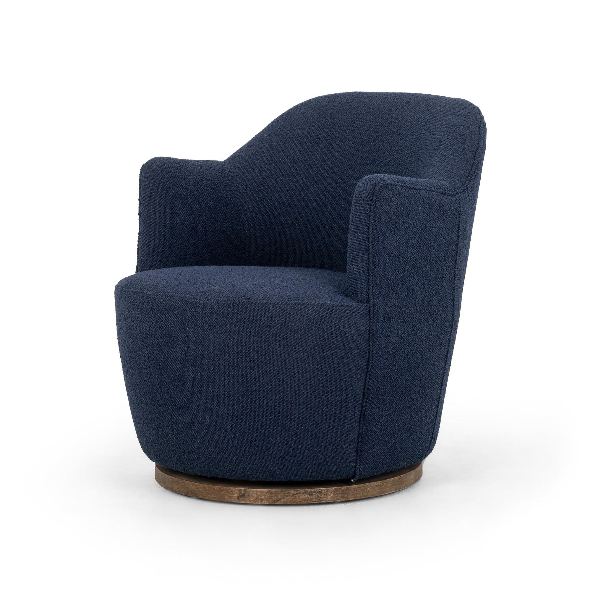 A contemporary armchair upholstered in a textured navy blue fabric. It features a rounded back and integrated armrests that curve gently downwards. The chair is supported by a circular, dark wood swivel base, allowing for 360-degree rotation. The upholstery has a boucle or similar textured finish. — 3D model