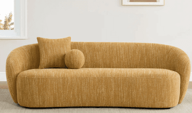 A modern sofa with a rounded silhouette. It features a textured, woven upholstery in a warm, golden-yellow hue. The sofa includes two decorative pillows: one square and one spherical, both matching the sofa's upholstery. The design emphasizes soft lines and a comfortable aesthetic. — 3D model