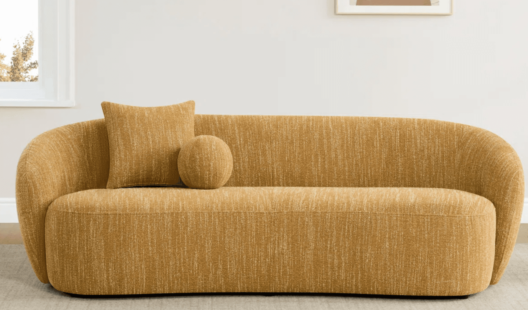 A modern sofa with a rounded silhouette. It features a textured, woven upholstery in a warm, golden-yellow hue. The sofa includes two decorative pillows: one square and one spherical, both matching the sofa's upholstery. The design emphasizes soft lines and a comfortable aesthetic. — 3D model