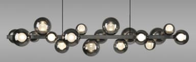 A modern linear suspension light featuring multiple spherical smoked glass shades attached to a dark horizontal bar. The shades are arranged in clusters and individually house light sources, emitting a warm glow. The fixture is suspended by two thin black wires. — 3D model