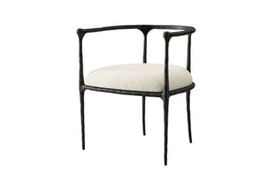 An armchair featuring a dark, heavily textured, and organically shaped cast metal frame paired with a light-colored, upholstered seat cushion. — 3D model