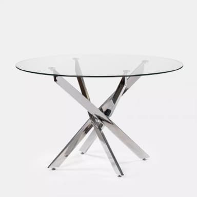 A modern round dining table featuring a blue-tinted tempered glass top and a polished chrome metal base with an X-shaped, sculptural design. The table is designed for contemporary spaces, offering a light and open aesthetic. — 3D model
