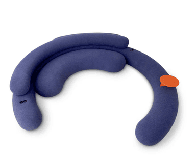 A modular sofa with a curved, organic design. It appears to be upholstered in a soft, textured fabric and features plump, rounded sections that form a seating area. There is a small, circular orange accessory attached to one of the sections, possibly a control or decorative element. The overall form is playful and contemporary. — 3D model