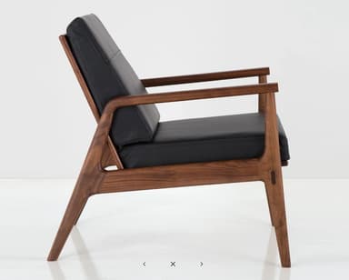 A two-view technical drawing of a modern lounge chair, featuring a sturdy wooden frame, padded seat and back cushions, and integrated armrests. The diagram includes precise dimensions for height, width, and depth. — 3D model