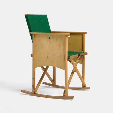 A rocking chair with a light-toned wooden frame, distinct plywood side panels, and a green fabric seat and backrest. — 3D model