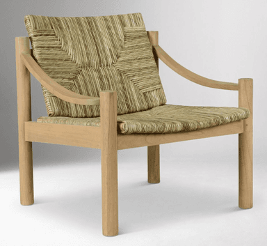 A low-profile lounge chair featuring a sturdy light-toned solid wood frame and a seat and backrest crafted from natural woven rush or similar plant fibers. The armrests are gently curved, connecting the front and back uprights. The weaving displays a distinct pattern, contributing to an organic and textured aesthetic. The chair's design emphasizes natural materials and clean, minimalist lines. — 3D model