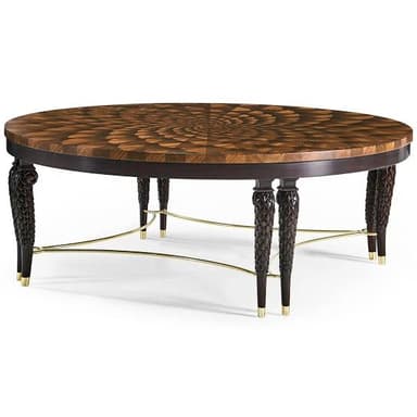 A sophisticated round coffee table featuring an intricately patterned marquetry top made from various wood veneers, creating a radial, spiraling design. The table is supported by four dark, elaborately carved and tapered legs with brass ferrules, connected by a delicate brass stretcher base. The overall aesthetic is one of luxury and fine craftsmanship. — 3D model