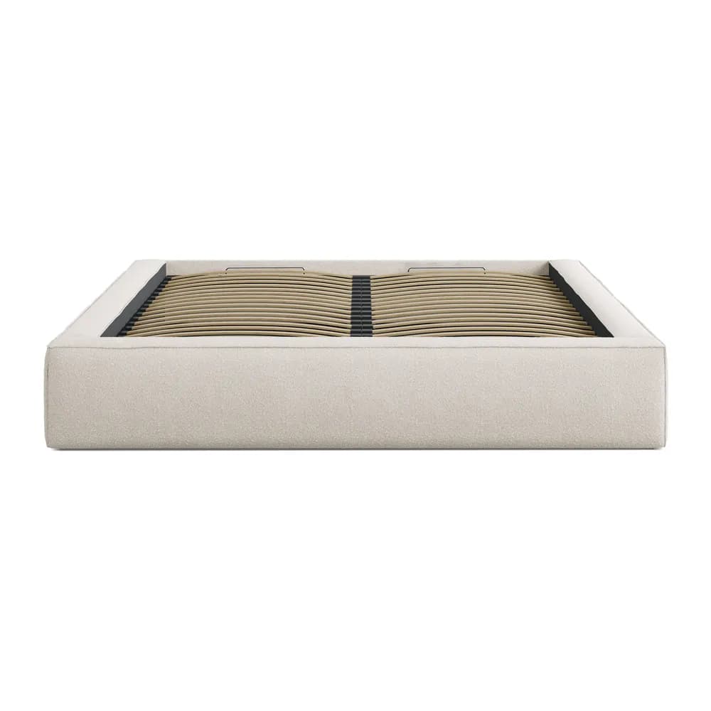 A minimalist, upholstered platform bed frame featuring a light beige, textured fabric. The frame has a low profile, with clean, straight lines, and does not include a headboard or footboard. The interior reveals a wooden slatted base system designed to support a mattress directly, negating the need for a box spring. The design emphasizes simplicity and a contemporary aesthetic. — 3D model
