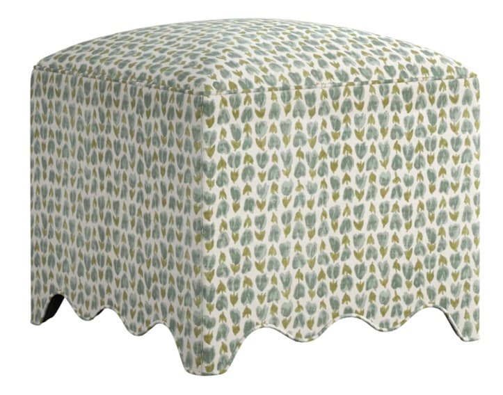 A square-shaped upholstered ottoman with a scalloped base and a repeating floral pattern. The top surface is slightly rounded, and the sides are vertically upholstered. It appears to be a single piece of furniture, suitable for use as a footrest or additional seating. — 3D model