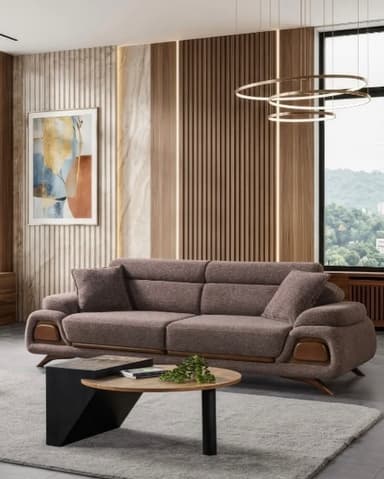 A contemporary three-seater sofa upholstered in a textured brown fabric, featuring distinctively curved armrests with integrated light wood-like panels and short, tapered wooden legs. It includes two matching throw pillows. — 3D model