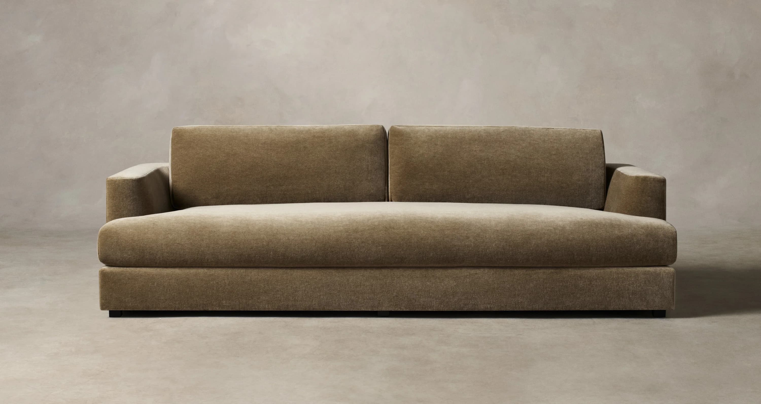 A modern, low-profile sofa with a plush upholstered finish. It features a straight silhouette with two seat cushions and two back cushions, a padded armrest on the right side, and a solid base. The upholstery appears to be a textured fabric with a matte finish. — 3D model