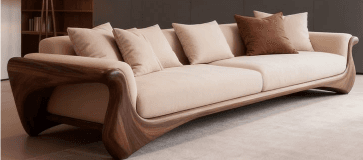 A long contemporary sofa featuring a distinctive, curved dark wood frame with light cream fabric upholstery and several throw pillows. — 3D model