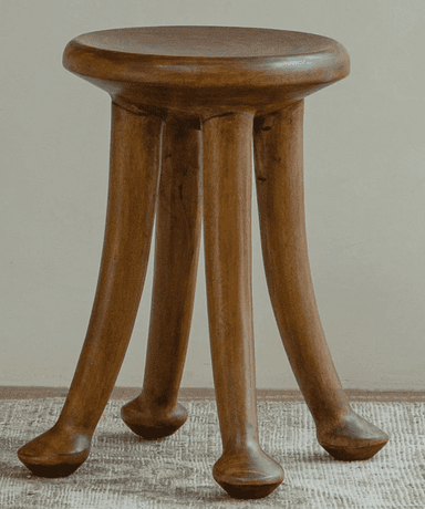 A minimalist wooden stool featuring a circular seat and three splayed, tapered legs with rounded ends, rendered in a dark brown wood finish. — 3D model
