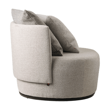A modern upholstered armchair featuring a rounded silhouette and a textured light-colored fabric. It has an integrated curved backrest and armrests, with two additional toss pillows for comfort. The chair rests on a dark, circular plinth base, suggestive of a swivel mechanism. — 3D model