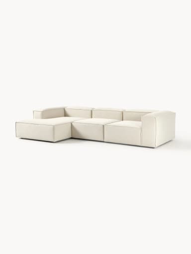 A modular sofa with clean lines and a low profile. It appears to be upholstered in a textured fabric and consists of multiple sections, suggesting flexibility in configuration. The sofa has a contemporary design with a boxy silhouette and visible stitching that delineates the segments. — 3D model