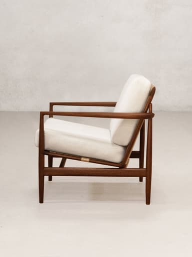 A mid-century modern lounge chair featuring a dark wooden frame and light-colored upholstered cushions. The design is characterized by clean lines and exposed joinery, with a slightly reclined posture for relaxation. — 3D model