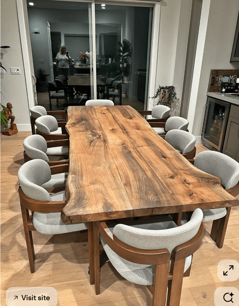 A live-edge coffee table with a thick, solid wood slab top and two rectangular pedestal legs. The wood exhibits a natural grain pattern with variations in color. — 3D model