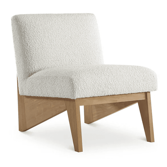 A modern armless chair with a low profile and upholstered seat and back. The chair features a textured, boucle-like fabric in a creamy white color. The base and legs are constructed from light-colored wood, exhibiting a natural grain and a minimalist design with angled supports. — 3D model